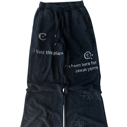 Black pants with white text and designs on a white background