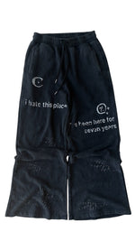 Black pants with white text and designs on a white background